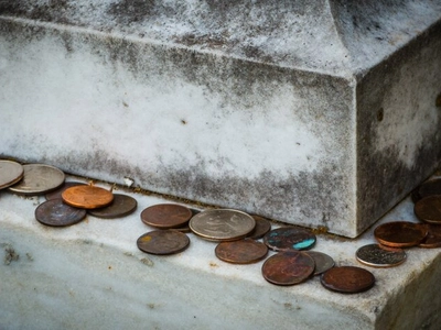 Meaning Behind the Tradition of Coins on Gravestones