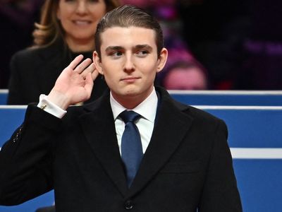Barron Trump reacts to the crowd after dad recognizes him at inauguration